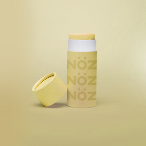 Front view of sunshine yellow Nözscreen with the cap leaning on the product